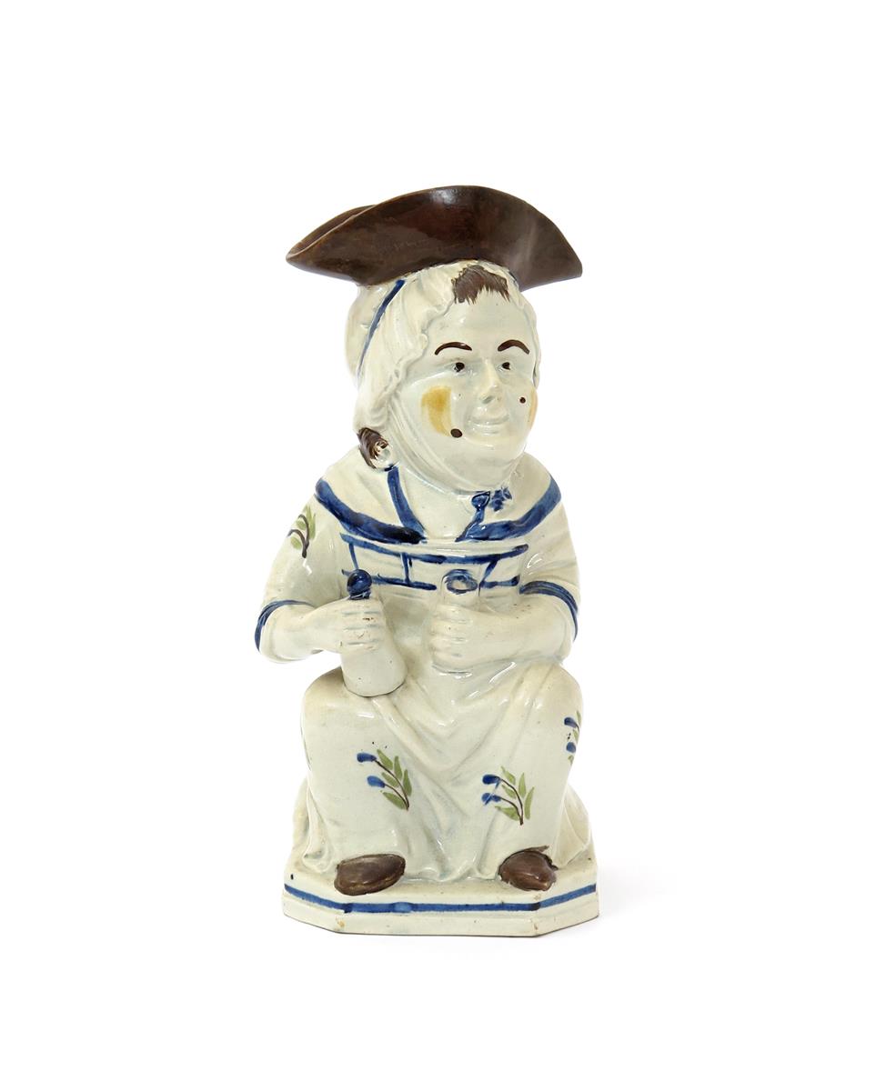 A Pratt ware Martha Gunn Toby jug, c.1800, seated and holding a gin bottle and glass, her dress