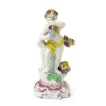 A Plymouth figure of Autumn, c.1768, modelled as a putto standing on a tall scrolled base and