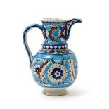 A Kutahya (Turkey) Iznik-style jug, 19th/20th century, brightly decorated with flowerheads and saz