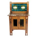 A marble topped oak wash stand possibly retailed by Liberty & Co, with tile back, red and white