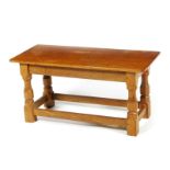 A Robert Mouseman Thompson oak low table, rectangular adzed top, with carved legs and carved mouse