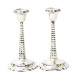 A pair of silver barley-twist candlesticks, stepped, circular base supporting tapering ribbed stem