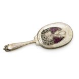 A Russian silver and enamel hand mirror, the back cast in low relief with cyclamen stems,
