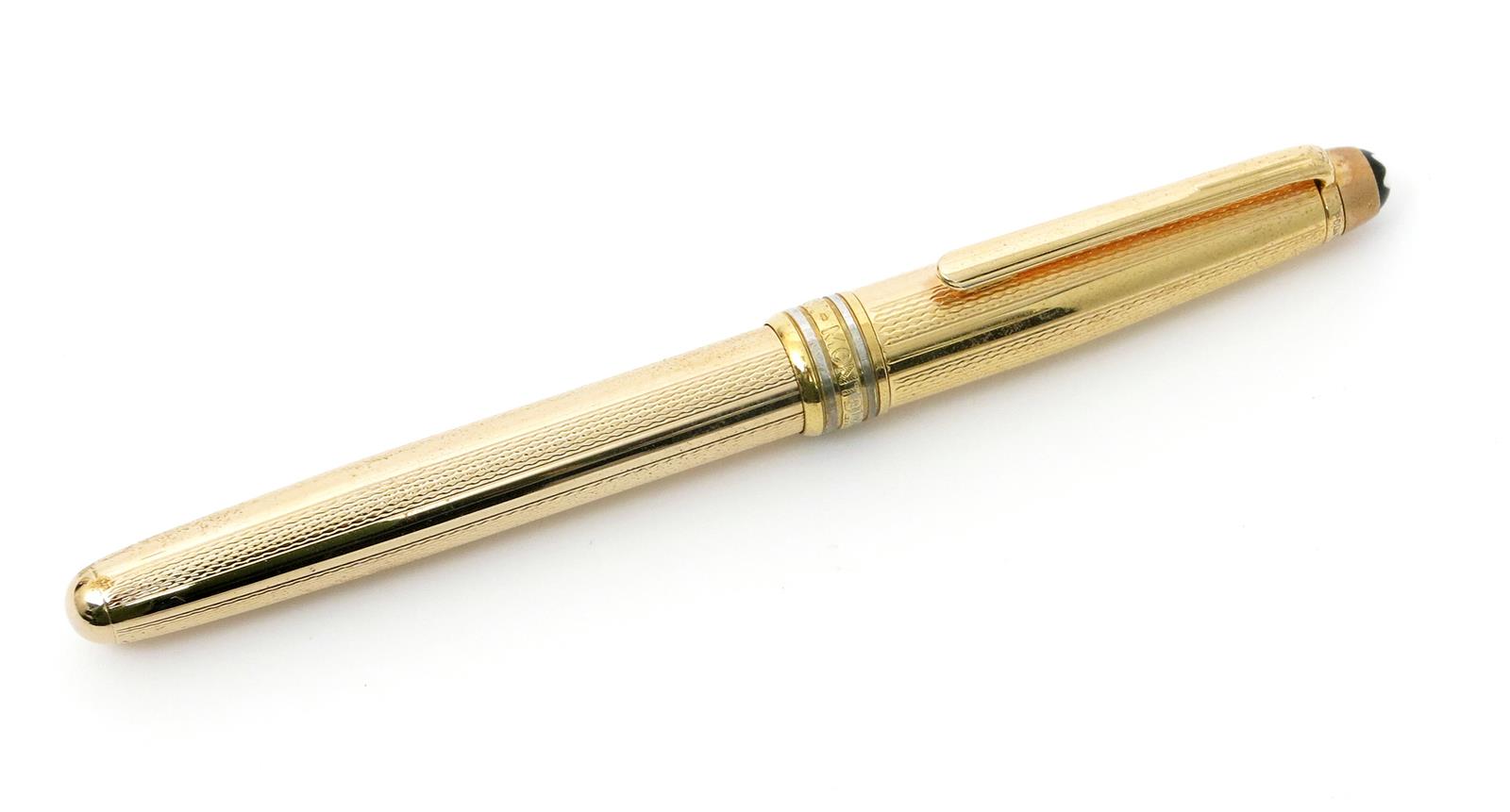 A Mont Blanc Meisterstuck rolled gold fountain pen, with engine turned decoration, 13.5cm. long