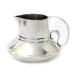 A Liberty & Co Cymric silver milk-jug designed by Archibald Knox, compressed form with tapering