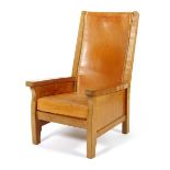 A Robert Mouseman Thompson oak Smoker's chair, with slung leather back and padded seat, carved mouse