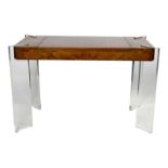 A Modernist burr walnut and perspex games table, with central board concealing storage