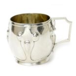 An Elkington & Co silver mug, barrel shape with cast strapwork decoration, applied angular handle,