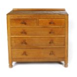 A Robert Mouseman Thompson oak chest of drawers, with adzed top, three graduated drawers below short