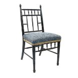 An ebonised wood Sussex child's chair, in the manner of Morris & Co, with turned spindle back and