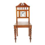 A mahogany hall chair, on turned legs, the back inset with Minton Shakespeare Series tile by John