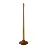 A Robert Mouseman Thompson oak floor lamp, on octagonal stepped base with carved mouse signature,