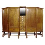 A large Arts and Crafts Cotswold School walnut wardrobe, two panelled doors flanked by similar