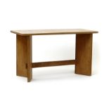 An oak occasional table attributed to Sidney Barnsley, rectangular plank top with four angled