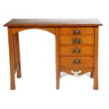 An Arts and Crafts oak desk possibly retailed by Liberty & Co, rectangular with flaring square legs,