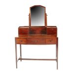 A walnut dressing table designed by Edward Barnsley, shaped top with three drawers, supporting