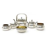 A Gorham & Co electroplated metal and ivory tea set, cast with foliate bands, comprising teapot