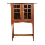 An oak "Holland" display cabinet after a design by George Walton, on slender, tapering square