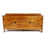 A Robert Mouseman Thompson oak sideboard, rectangular with adzed top, two cupboards flanking central