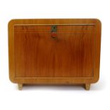 A Modernist Laszlo Hoenig blonde beech desk top bureau, the fall-front door with bakelite circular