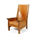 A Robert Mouseman Thompson oak Smoker's chair, with slung leather back and padded seat, carved mouse