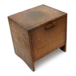 An oak coal box by Edward Barnsley, with wide dovetail joints, hinged door and metal liner, 37cm.