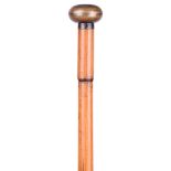 An unusual 7mm walking cane 'blow' gun, bamboo clad brass barrel, the brass top unscrewing to reveal