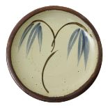 ‡ Bernard Leach (1887-1979) a St Ives Pottery plate, painted to the well with a simple willow tree