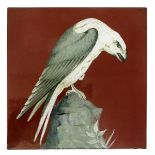 A large Minton's Art Pottery Studio tile, painted with a white falcon, resting on a rock outcrop,