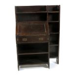 A Liberty & Co oak bureau and bookshelf, with patinated metal furniture, applied ivorine label to