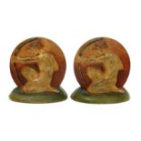 A Pair of Compton Potter's Art Guild book ends, circular each cast in relief with an archer,