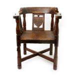 A Robert Mouseman Thompson oak armchair, with dated crest for 1934, the curved arms with carved