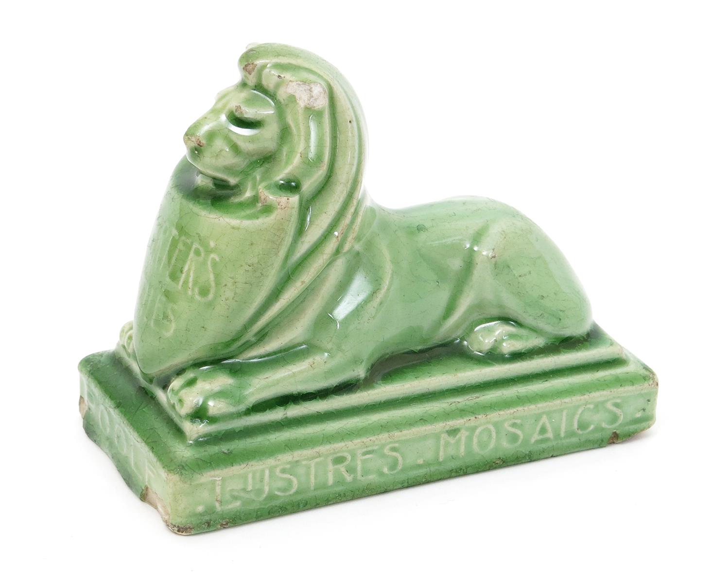 Carter's Tiles Poole an advertising paperweight, modelled as a lion dormant holding a shield,