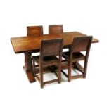 A Robert Mouseman Thompson oak dining table and four chairs, the chairs with leather seats, the