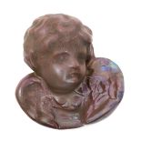 A rare Carter's Poole Cherub paperweight, covered in a red lustre glaze, impressed Carter's Poole