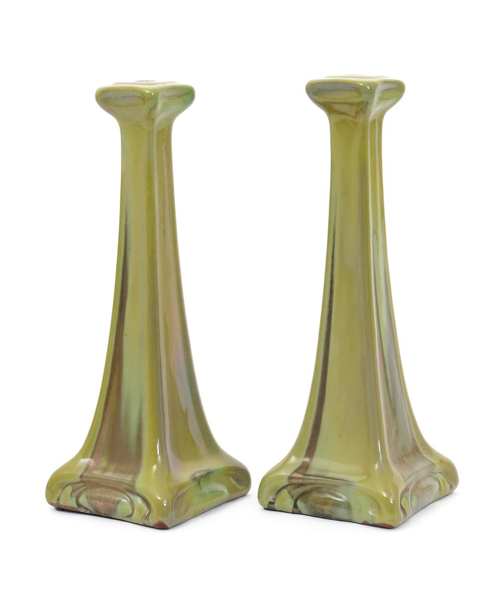 A pair of Carter's Poole lustre tall candlesticks designed by Owen Carter, dated 1906, tapering