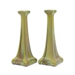 A pair of Carter's Poole lustre tall candlesticks designed by Owen Carter, dated 1906, tapering