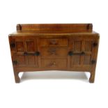 A Robert Mouseman Thompson oak buffet sideboard, with adzed top, three central drawers flanked by