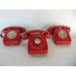 Three similar vintage Bakelite cased telephone sets, each with red colourway (3)