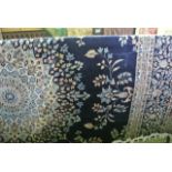 A substantial good quality woven wool rug, the deep navy blue field interspersed with symmetrical