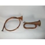 A copper military bugle with applied stamp CSA together with a further copper horn (2)