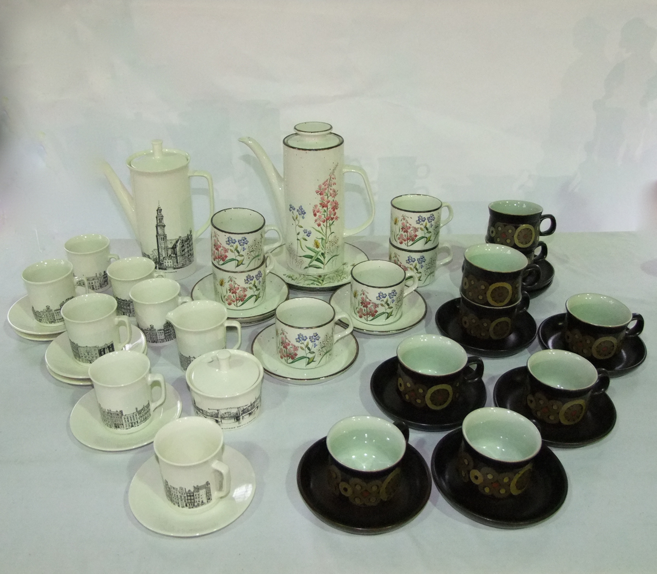 A collection of Villeroy & Boch coffee wares with black printed topographical detail on a cream