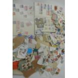 A carrier bag containing a large quantity of unsorted stamps, two stock books containing a