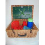 An Antler brand wicker picnic hamper containing a quantity of plastic picnic accessories