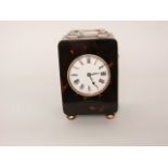 A tortoiseshell and silver mounted mantle clock with enamelled dial and eight day striking movement,