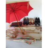A 19th century carved ebony and ivory mounted walking stick, three vintage umbrellas, a carpet