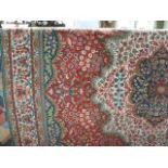 A wool work carpet, the central claret ground heavily decorated with a symmetrical medallion with