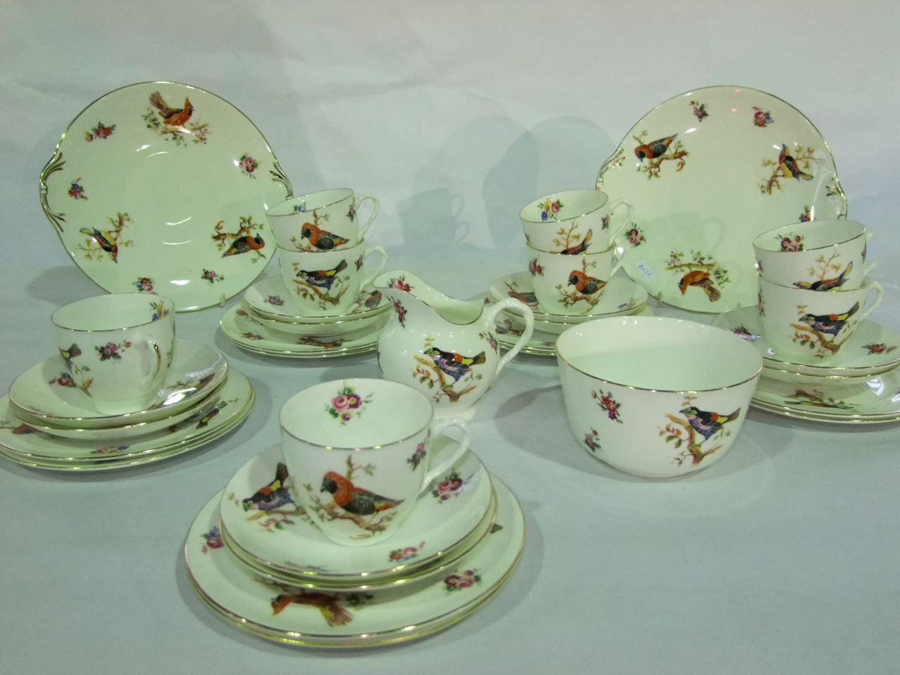 A collection of Royal Doulton tea wares with printed bird and floral spray detail pattern number