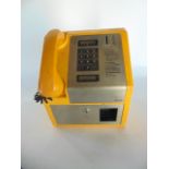 A 20th century British payphone unit, the squared metallic casing with brightly coloured yellow