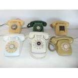 Three vintage ivory Bakelite cased telephone sets together with two further white examples and